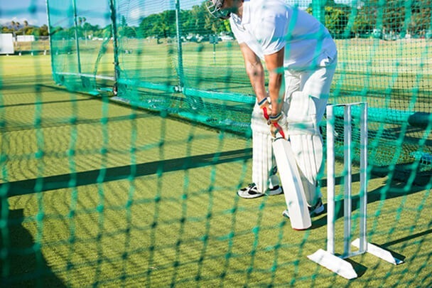low-section-of-man-playing-cricket-at-field